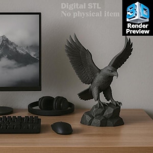 May include: A dark gray eagle sculpture with outstretched wings, perched on a rocky base. The sculpture is displayed on a wooden desk, alongside a computer monitor, keyboard, mouse, and headphones. The image includes the text "Digital STL No physical item" and "Render Preview".