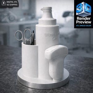 May include: A white medical device organizer with a bottle labeled "Ultrasound Gel", a probe, and a compartment holding scissors and a pen. The base is silver. The image includes the text "DIGITAL STL NO SHIPPING" and "Render Preview STL SINGLE-COLOR".
