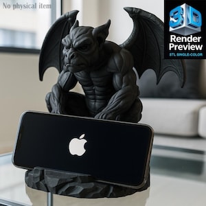 Puede incluir: Un soporte para teléfono con forma de gárgola negra con un smartphone que muestra el logotipo de Apple. La gárgola está detallada con alas y una expresión severa. El soporte está hecho de un material oscuro y texturizado. El texto "Render Preview STL SINGLE-COLOR" es visible.