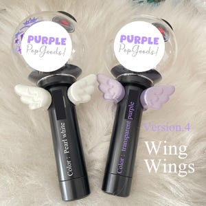 May include: Two black light sticks with clear globes, each with a "PURPLE Pop Goods!" sticker. One stick has white wings, the other has transparent purple wings. Text on the sticks reads "Color: Pearl white" and "Color: transparent purple."