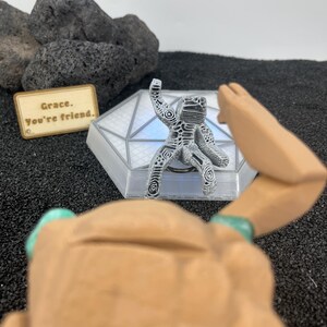 Cute Rocky companion figure with upside-down thumbs-up gesture from Project Hail Mary for Andy Weir fans