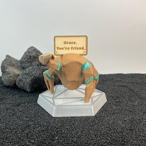 Andy Weir inspired Project Hail Mary desk companion featuring Rocky alien design, customizable emotional support sign, and modern RGB sci fi display stand