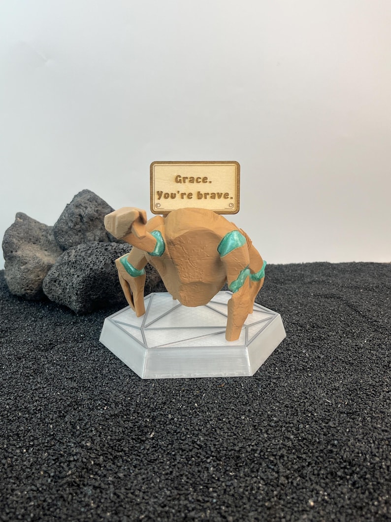 BookTok sci fi collectible inspired by Rocky and Grace from Project Hail Mary, cozy emotional support desk figure with futuristic glowing display base