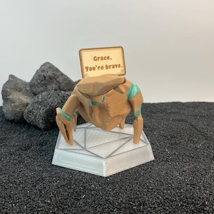RGB Rocky and Grace collectible inspired by Project Hail Mary glowing beside keyboard in cozy sci fi setup