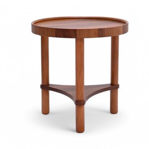 May include: A small, round wooden side table with a dark brown tabletop and three cylindrical legs. The legs are connected by a triangular support near the base. The table is approximately 50 cm in diameter.