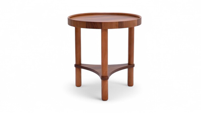 May include: A small, round wooden side table with a dark brown tabletop and three cylindrical legs. The legs are connected by a triangular support near the base. The table is approximately 50 cm in diameter.
