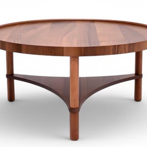 May include: A circular wooden coffee table with a tray-style top and three legs. The table is made of dark brown wood with a lighter brown central support and a triangular shelf. The design is modern and minimalist.