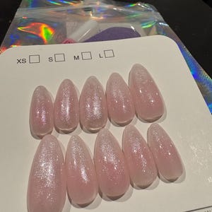 Almond shaped pink with white and glitter.