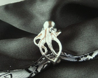 an "Octopus" ring in Sterling Silver w/Tahitian Black pearl body and blue diamond eyes