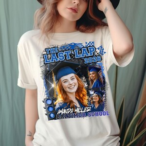 May include: A cream-colored t-shirt featuring a graphic print with the text THE LAST LAP 2026, AMANDA MILLER, and BALTIMOR SCHOOL. The design includes a blue traffic light, checkered flags, and three photographs of a graduate in a blue cap and gown.