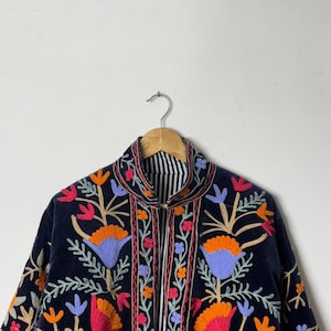 Velvet, Suzani, Jacket, Coat, Boho, Bohemian, Embroidered, Handmade, Artisan, Rabbit, Bunny, Floral, Flowers, Vintage, Ethnic, Traditional, Uzbek, Indian, Fashion, Outerwear, Winter, Casual, Festival, Gift, Womens, Unisex, Luxury, Elegant, Colorful, Soft, Cotton, Lining, Designer, Unique, Folk, Motif, Stitching, Needlework, Craftsmanship, Heritage, Boutique, Trendy, Statement, Layering, Cozy, Warm, Short, Premium, Stylish, Wearable.