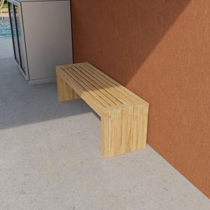 May include: A light-colored wooden bench with a slatted seat and rectangular legs. The bench is positioned against a reddish-brown wall and a light gray concrete surface. The bench is made of vertical wooden planks.