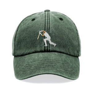May include: A green baseball cap with a curved brim and a small, embroidered image of a batter swinging a bat. The cap is a solid green color and has a classic six-panel design.