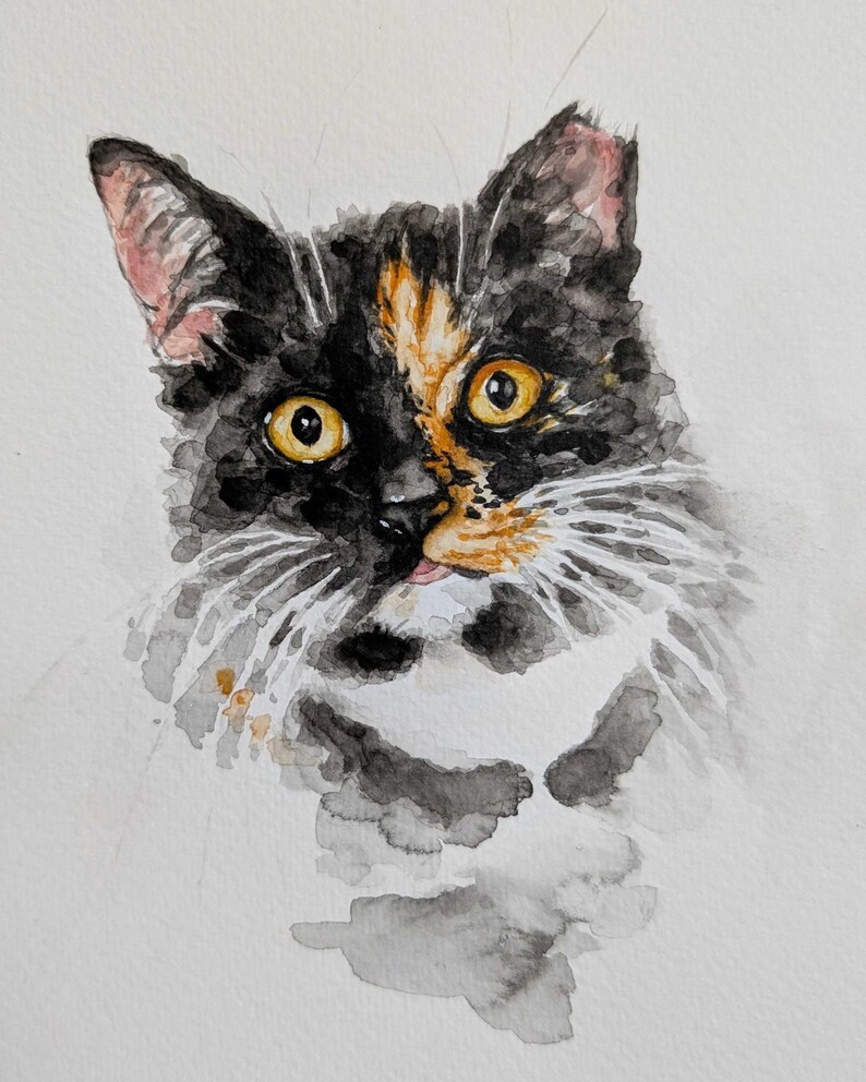 May include: Watercolor painting of a cat's face. The cat has black, orange, and white fur with yellow eyes. The painting is done in a loose, expressive style, with visible brushstrokes and watercolor washes.
