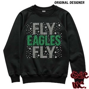 May include: Black sweatshirt with the text "FLY EAGLES FLY" in silver and green rhinestone-like letters. The design includes small white dots, and the sweatshirt has a crew neck and long sleeves.