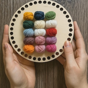 May include: A wooden basket base with evenly spaced holes around the edge, holding 16 small balls of colorful yarn. The yarn colors include yellow, navy, green, dark green, cream, white, red, light blue, brown, pink, purple, and orange.