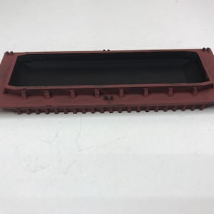 May include: A red wooden model of a barge with a black interior. The barge has a flat bottom and a rectangular shape.