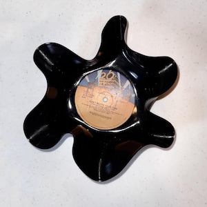 May include: A black, star-shaped decorative dish made from a repurposed vinyl record. The center label reads "Don't Waste Your Time" and features the 20th Century Fox logo. A unique, upcycled item.