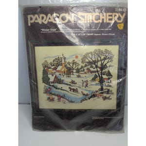 May include: A white ceramic mug with a black handle and the text "But First, Coffee" in a black, bold font. The mug is sitting on a wooden surface. The mug is approximately 4 inches tall.