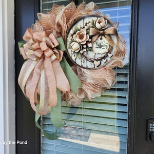 May include: A rustic wooden sign with the text "Welcome to our home" in white lettering. The sign features a distressed finish and a simple, inviting design, perfect for a front porch or entryway.