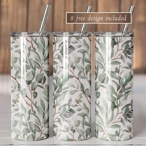 Puede incluir: Tres vasos de acero inoxidable con un diseño botánico de hojas y ramas verdes sobre un fondo blanco. Cada vaso tiene una pajita plateada y una tapa transparente. El texto "8 free design included" se muestra en la parte superior.