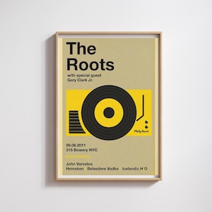 Può includere: Un poster incorniciato con sfondo beige presenta il testo "The Roots" in grassetto nero. Sotto, una grafica gialla raffigura un giradischi con un disco in vinile nero. Il testo aggiuntivo include la data, il luogo e gli sponsor.