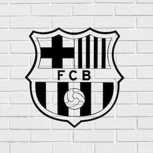 May include: Black and white FC Barcelona crest. The crest is shield-shaped with a cross, vertical stripes, and a soccer ball. The letters "FCB" are displayed in the center. The image is set against a white brick wall.