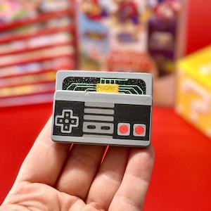 May include: A set of three ceramic canisters with lids, featuring a blue and white floral pattern. The canisters vary in size, with the largest approximately 8 inches tall. Ideal for kitchen storage.