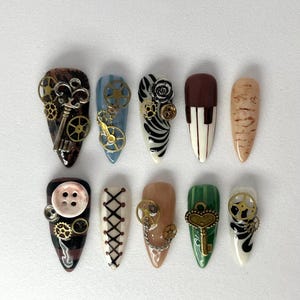 May include: A set of ten steampunk-themed artificial nails. Designs include keys, gears, buttons, and lace-up patterns. Colors include brown, blue, white, black, and green. Each nail has a unique design with intricate details.