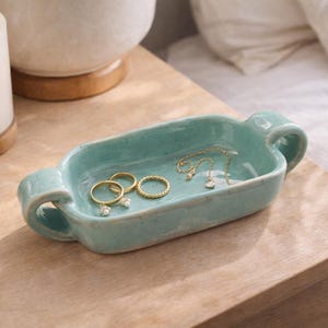 May include: A rustic wooden sign with the text "Welcome to our home" in a handwritten style. The sign is rectangular, with a distressed finish, and features a simple, inviting design. It's suitable for indoor or outdoor use.