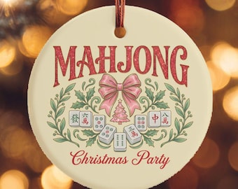 May include: A round, cream-colored Christmas ornament with the word "MAHJONG" in red script. Below, a pink bow and Mahjong tiles are surrounded by green leaves. The text "Christmas Party" is below the design.