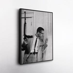 Malcolm X Holding Gun Canvas – Powerful Civil Rights Wall Art, Iconic Historical Photo Print, Revolutionary Decor, Gift for History Buffs