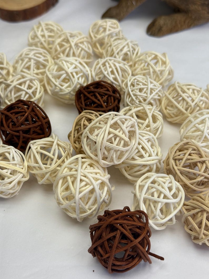 May include: A selection of decorative woven spheres in shades of brown and cream. The spheres are made from natural materials and vary in size, creating a textured, organic aesthetic. Suitable for home decor.