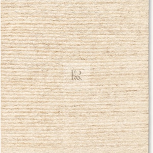 May include: A rectangular, beige rug with a textured, horizontal striped pattern. The rug has a neutral color palette, suitable for various interior design styles. A logo is visible in the bottom center.