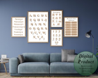 May include: A set of framed educational prints featuring an alphabet, shapes, numbers, and days of the week, in a neutral colour scheme. The prints are displayed above a blue sofa, creating a decorative and educational wall display.
