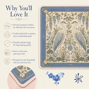 May include: A rectangular neoprene game mat featuring a cream background with a blue border and a central illustration of two herons surrounded by lotus flowers and wisteria. The mat has a light pink stitched edge and a smooth surface texture.