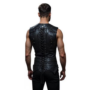 May include: Black leather vest with shoulder accents and a lace-up back. The vest features decorative stitching and metal studs. The person is wearing black trousers. The background is white.