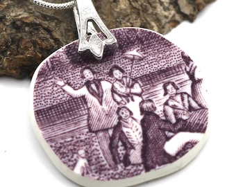 May include: A square pendant necklace featuring a vintage illustration in shades of purple and white. The pendant depicts a scene with several figures. The silver-tone bail connects to a silver chain.