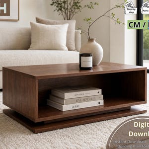 May include: A rectangular wooden coffee table featuring a hollow centre shelf for storage. The table has a dark brown finish and a flat base. Three stacked books are placed inside the open compartment of the table.