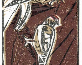 May include: A woodblock print of two birds, one perched on top of the other. The birds are brown, white, and black with a red accent on the lower bird. The background is a dark brown with white and black lines.