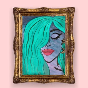 May include: An artistic portrait of a woman with teal hair and closed eyes, framed in a gold ornate frame. The woman has red lips and is wearing star and crescent moon earrings. The background is a mix of blue and purple.