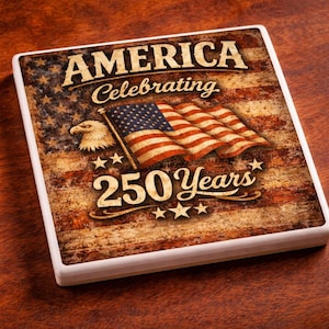 May include: Square ceramic coaster with a patriotic design. The coaster features the American flag, an eagle, and the text "AMERICA Celebrating 250 Years" in a vintage style. The coaster has a white border.
