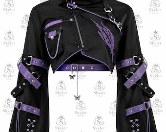 May include: A black cropped jacket featuring purple accents, a high collar with a buckle strap, and an asymmetrical zipper. The sleeves have multiple buckled straps and lace-up details. A silver chain with butterfly charms hangs from the hem.