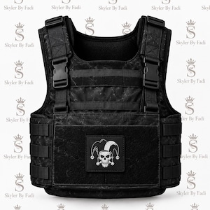 May include: A black tactical vest featuring a subtle marble-like pattern, adjustable shoulder straps with plastic buckles, and horizontal webbing straps. A square patch on the front displays a white graphic of a jester skull with a jester hat.
