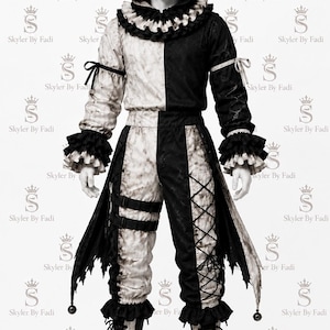 May include: A two-toned black and white jester costume featuring a hooded top with a ruffled collar, long sleeves with ruffled cuffs, and matching pants with side lacing and straps. The fabric has a mottled texture, and the hood includes bells.