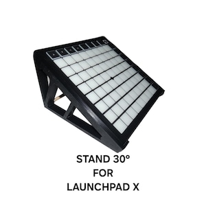 May include: Black wooden stand angled at 30 degrees, designed for a Launchpad X. The stand has a grid of white and black squares, with buttons at the top. Text on the image reads: STAND 30° FOR LAUNCHPAD X.