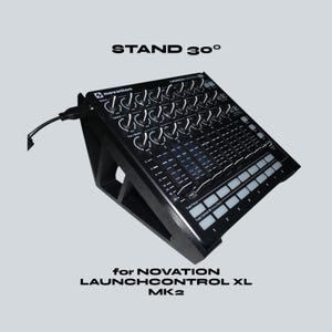 May include: Black stand for a Novation Launchcontrol XL MK2, angled at 30 degrees. The stand is designed to hold the Launchcontrol XL MK2, with the text "STAND 30°" and "for NOVATION LAUNCHCONTROL XL MK2" visible.