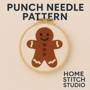May include: A punch needle pattern featuring a gingerbread man design. The gingerbread man is brown with white icing details and red button accents, set against a white fabric background within a wooden embroidery hoop. Text at the top reads "PUNCH NEEDLE PATTERN".
