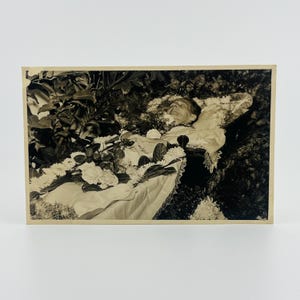 Vintage Post-Mortem Photograph | Woman in Coffin with Floral Surround (c. 1920s–1940s)