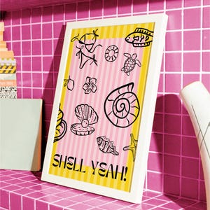 May include: White framed art print with a pink and yellow striped background. The print features black line drawings of seashells, a bikini, and the text "SHELL YEAH!"